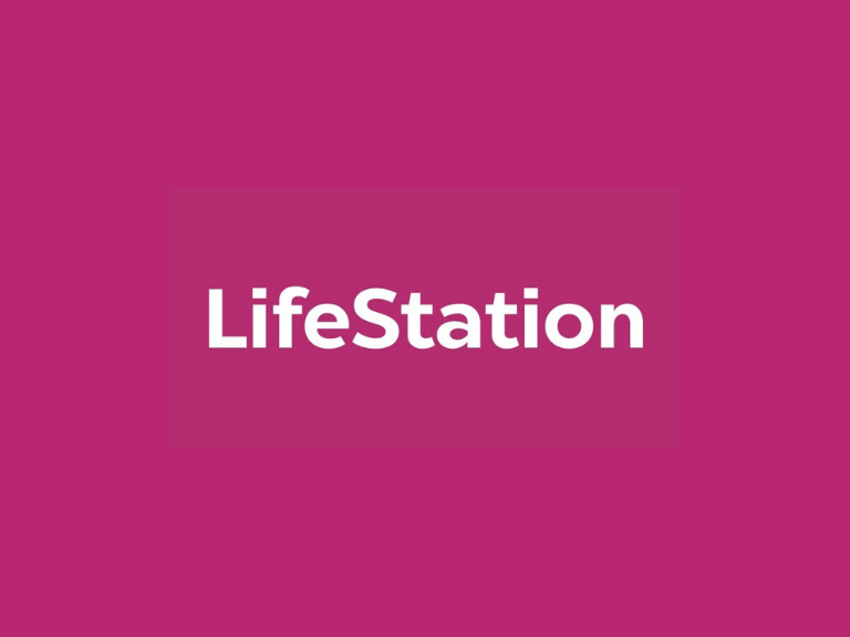Life Station banner featuring an elderly couple outdoors with text about free or reduced-price medical alert systems