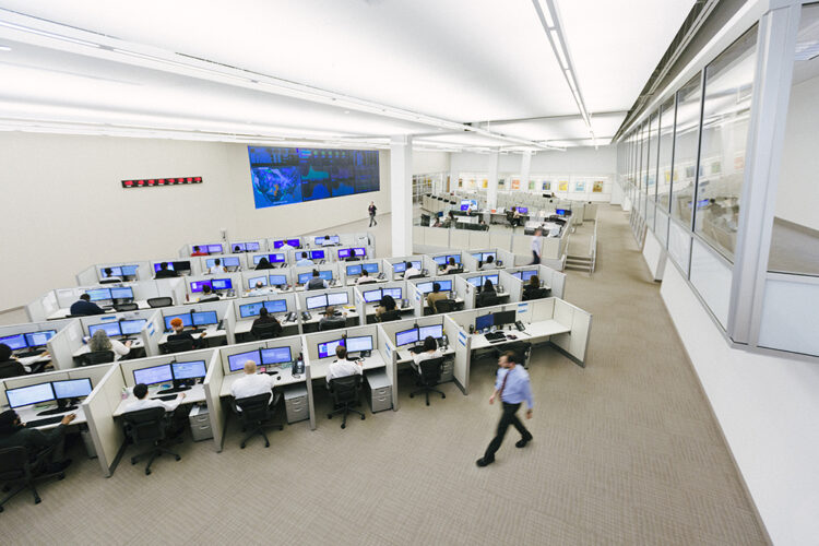Monitoring center with desks and computer screens demonstrating professionalism