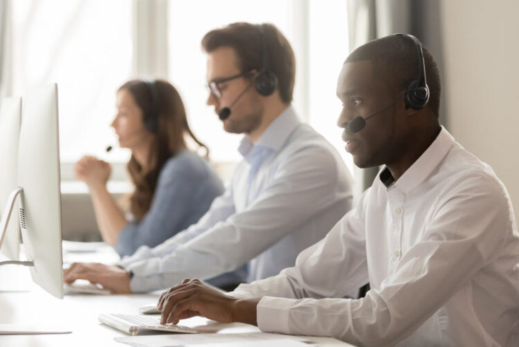Team of operators with headsets monitoring medical alert systems, ensuring rapid response for emergencies.