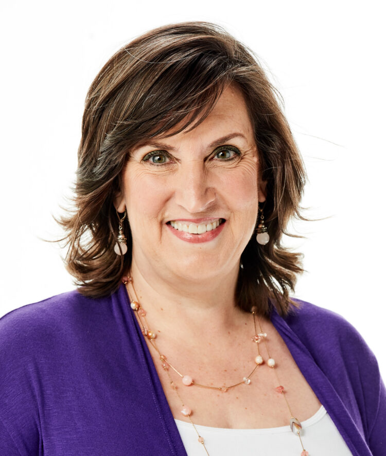 Confident woman smiling warmly, representing the empowerment and positivity associated with the Positive Aging Quotient.