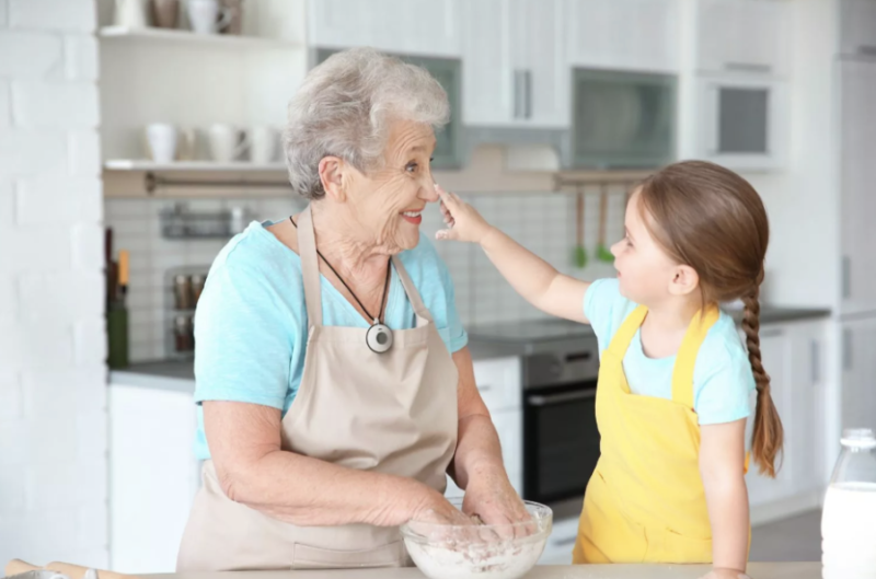 A Grandma with Her Grandchild with a LifeStation Medical Alert System around her neck