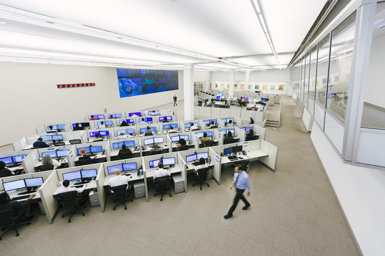 Monitoring center with desks and computer screens