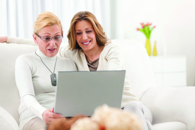 Mother and daughter with medical alert on computer