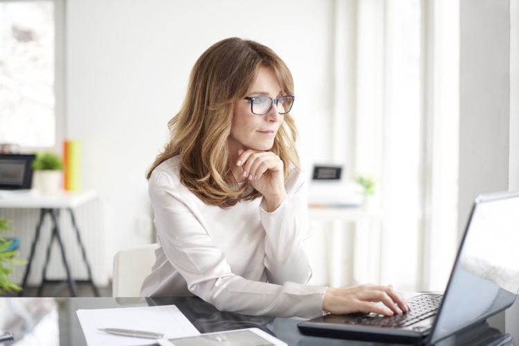 Woman in office working on laptop