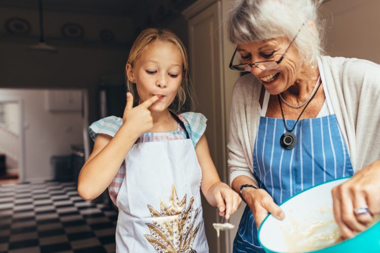 Grandmother and granddaughter making food