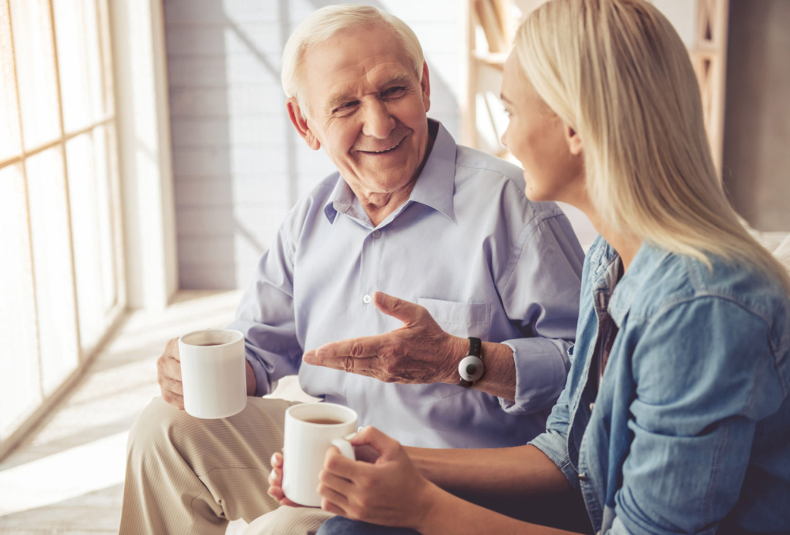 Elderly father sitting and talking with daughter