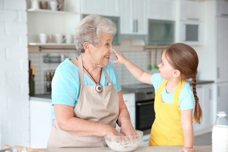 Grandmother with granddaughter in kitchen