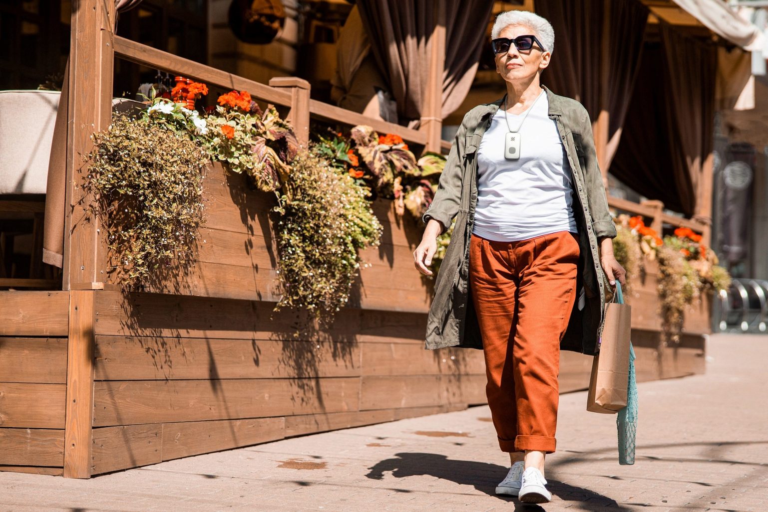 Woman walking outside with medical alert around neck