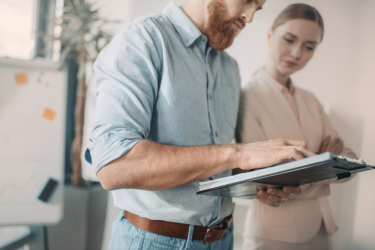 Worker on tablet next to woman